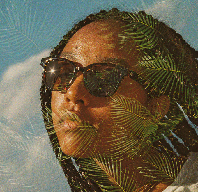 woman in sunski sunglasses with palm vibes