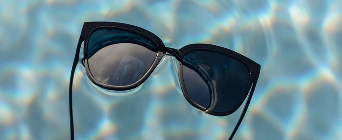 sunski camina sunglasses floating in a pool