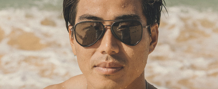 man at the beach in astra sunglasses
