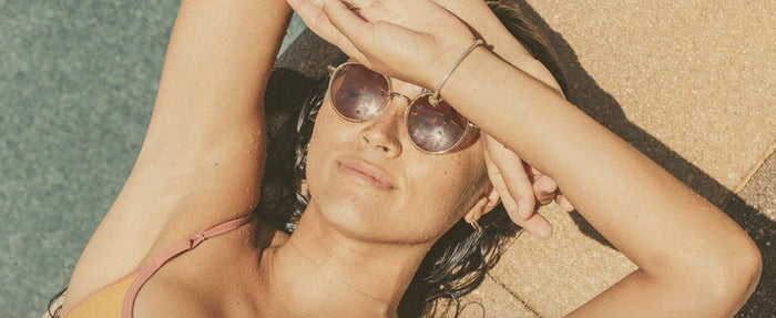 woman at the pool in baia sunglasses