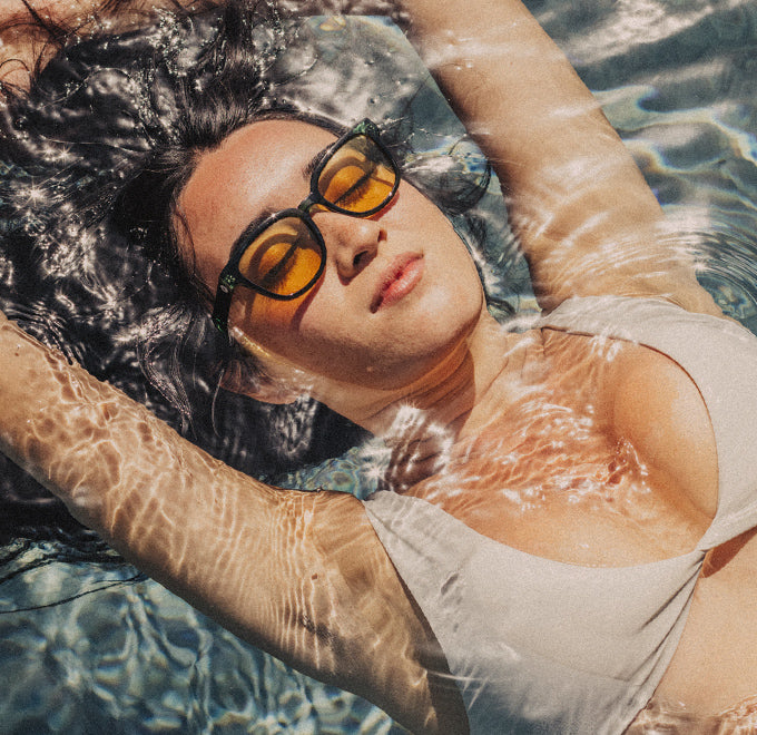 woman in a pool wearing sunski tinted sunglasses