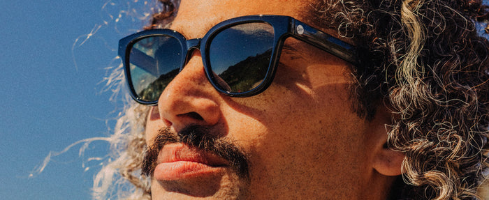 guy looking into the distance wearing sunski miho sunglasses