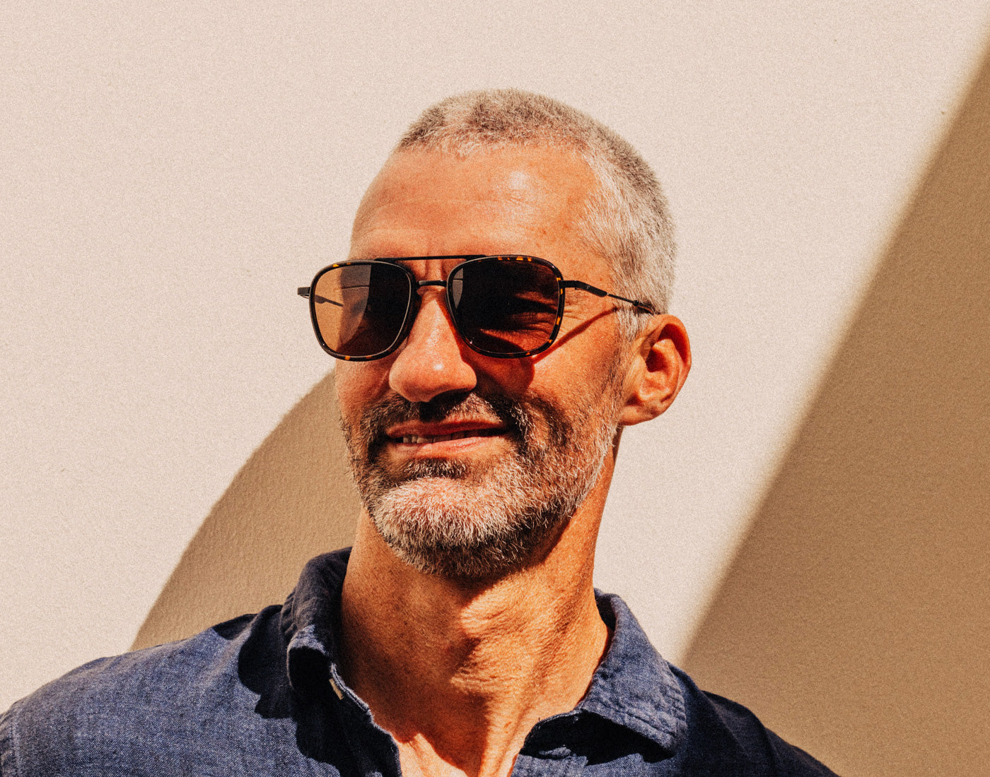 man smiling wearing sunski estero sunglasses