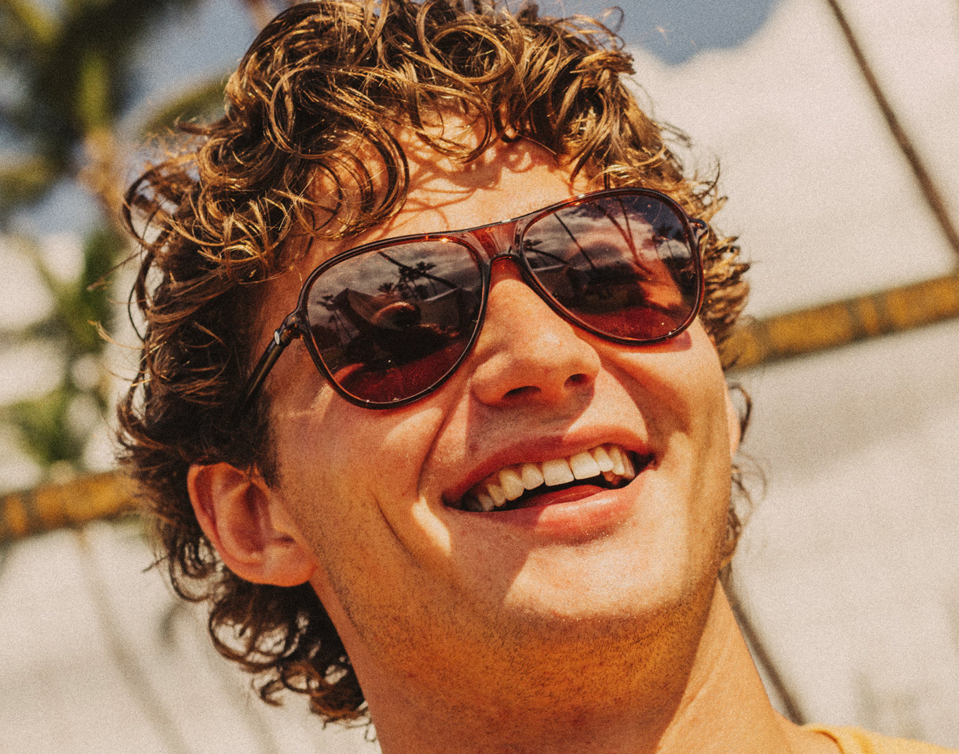 guy laughing wearing sunski foxtrot sunglasses