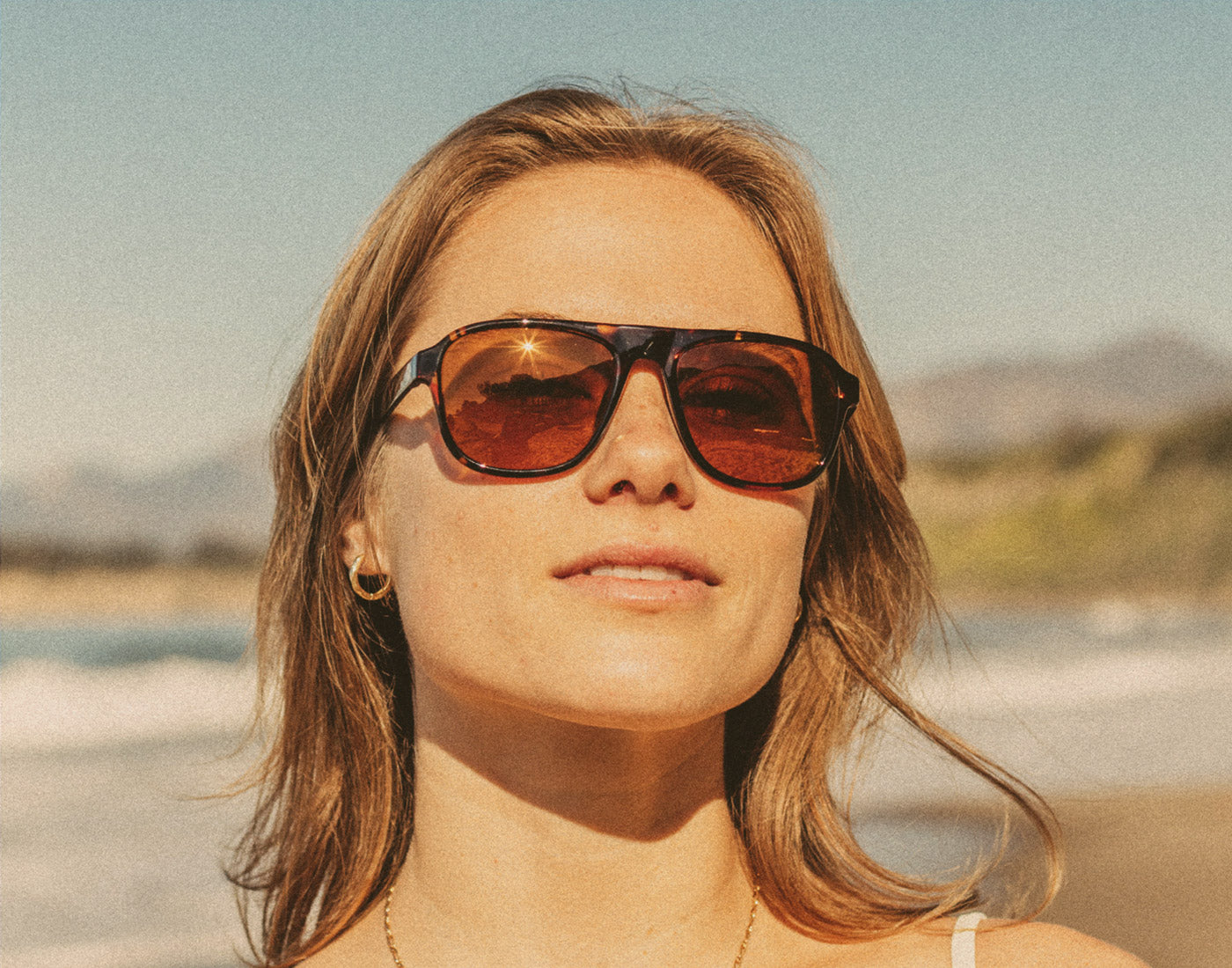 woman looking at camera wearing sunski shoreline sunglasses