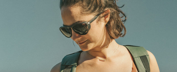 woman looking down wearing sunski treeline sunglasses