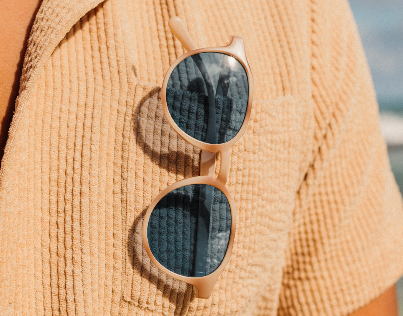 sunski vallarta sunglasses hanging on shirt pocket