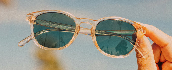close up of hand holding sunski yuba sunglasses