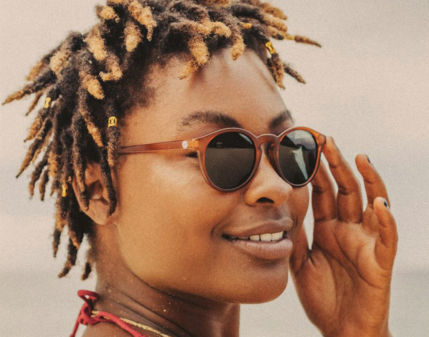 woman looking over her shoulder wearing sunski dipsea sunglasses