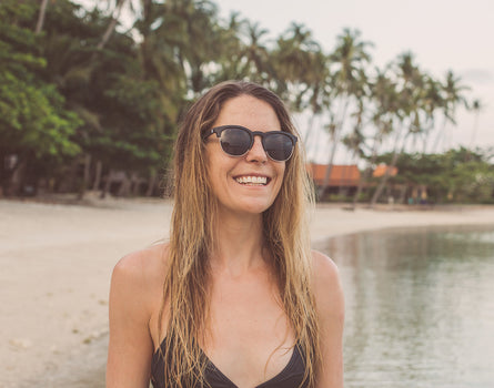 girl smiling wearing sunski avila sunglasses