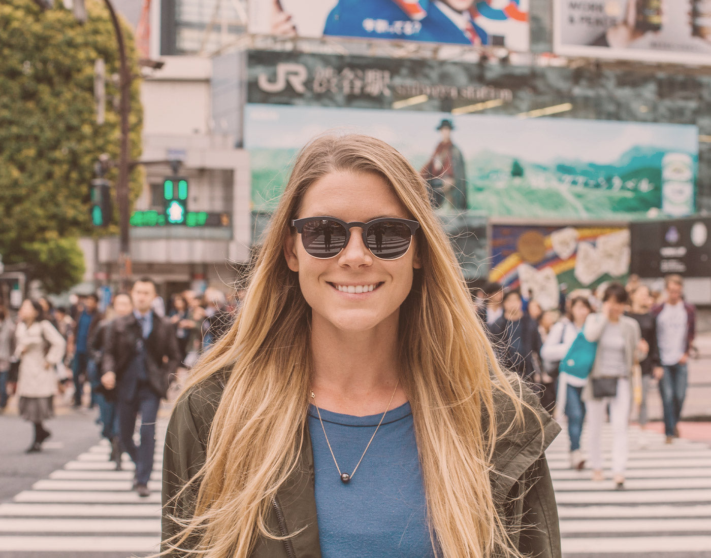 girl in a city wearing sunski avila sunglasses