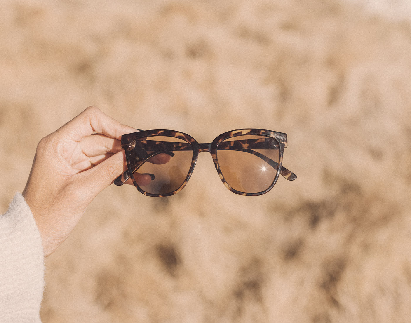hand holding sunski camina sunglasses