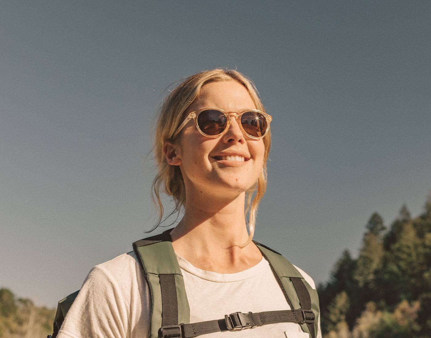 girl backpacking wearing sunski dipsea sunglasses