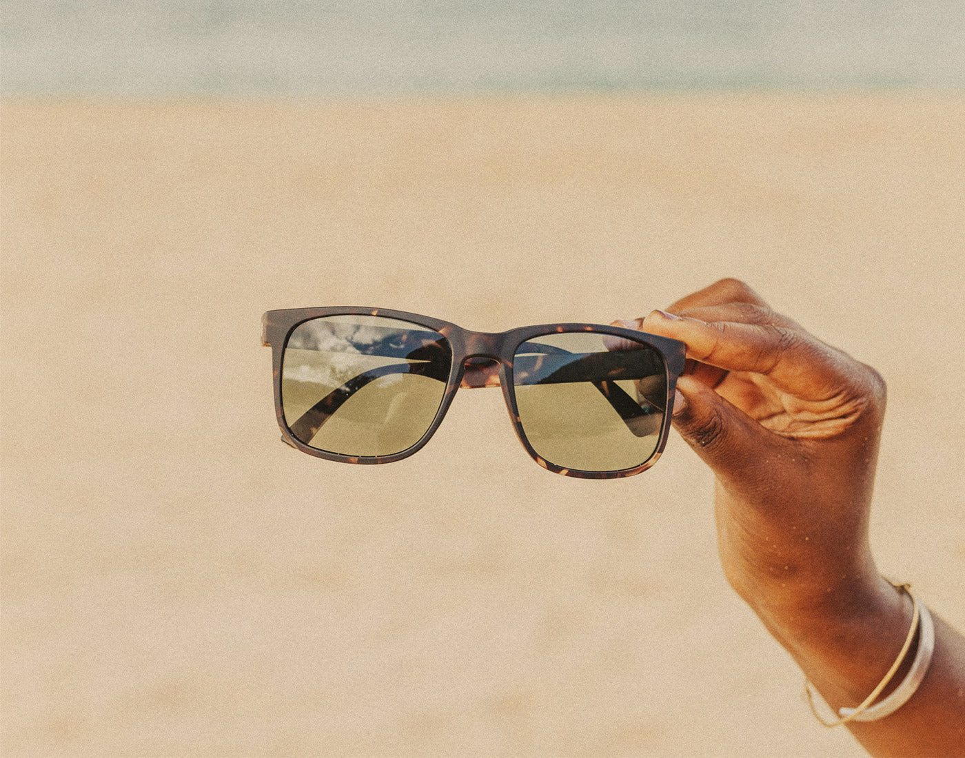 hand holding sunski kiva sunglasses