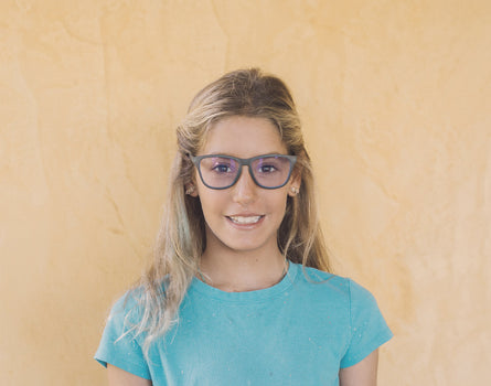 girl smiling wearing sunski mini headland bluelight glasses