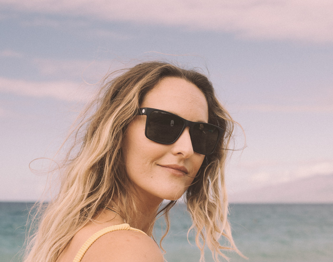 girl looking over shoulder wearing sunski puerto sunglasses