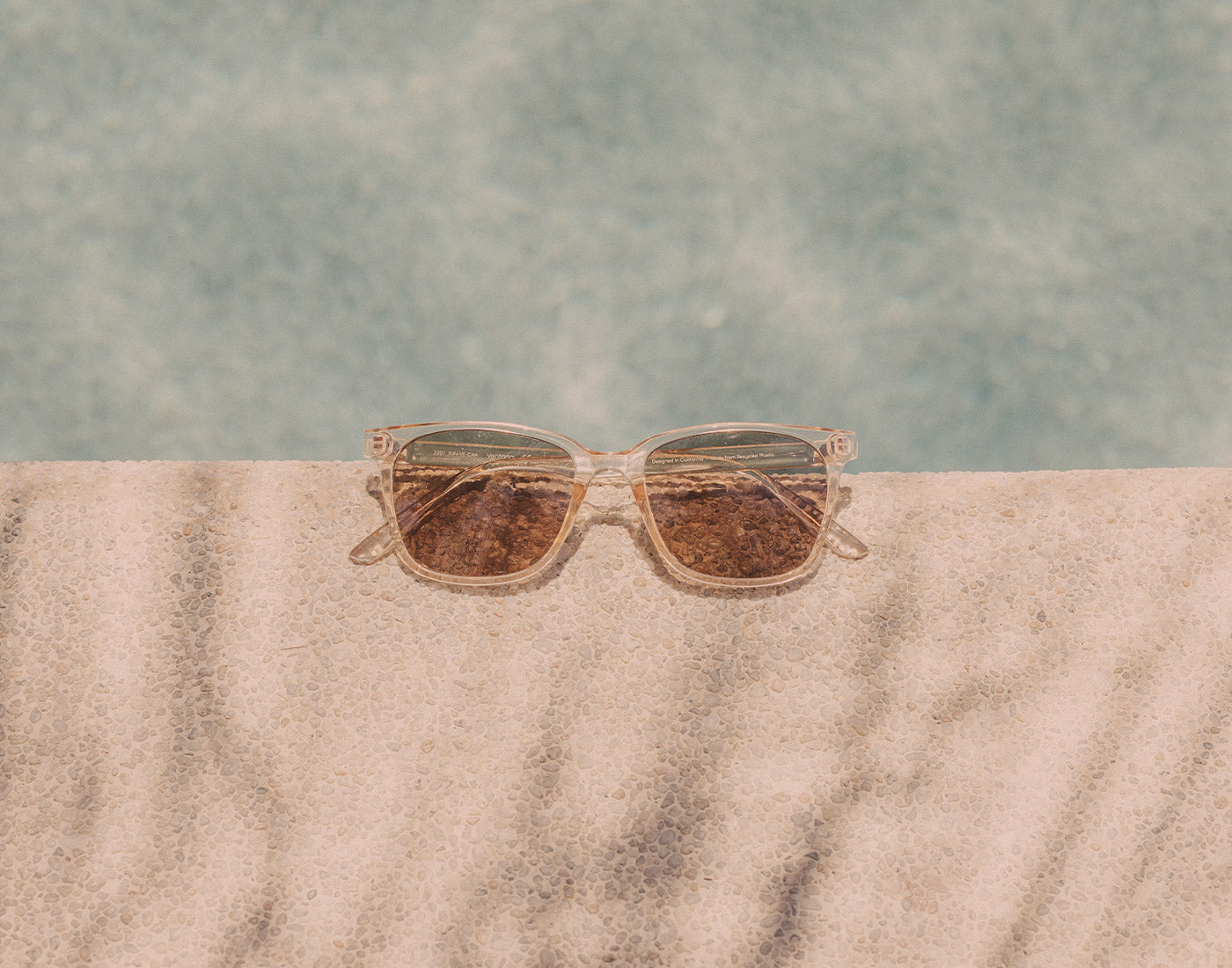 sunski ventana sunglasses on side of pool