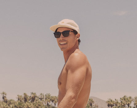 guy in a hat wearing sunski ventana sunglasses