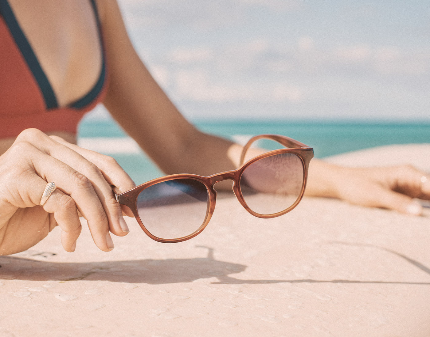 hand holding sunski yuba sunglasses