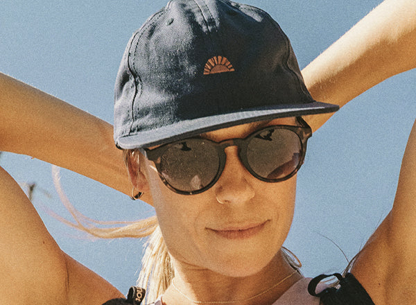 close up of woman's face wearing sunski sunburst hat