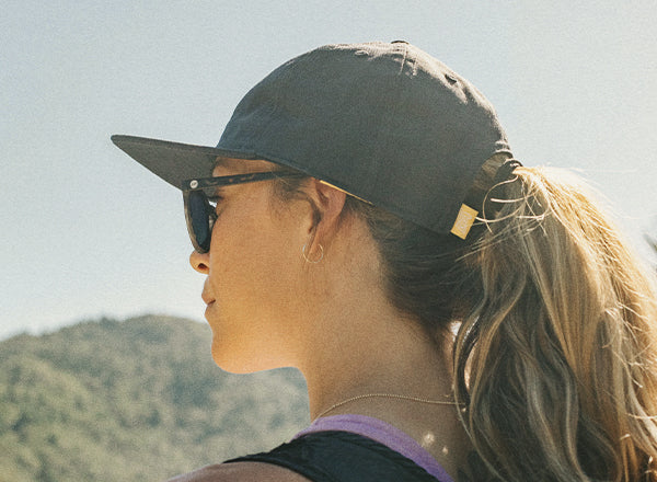 back angle of sunski sunburst hat on a woman