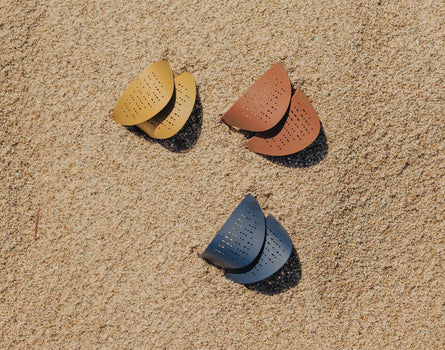 sunski tera sun shields laying the sand