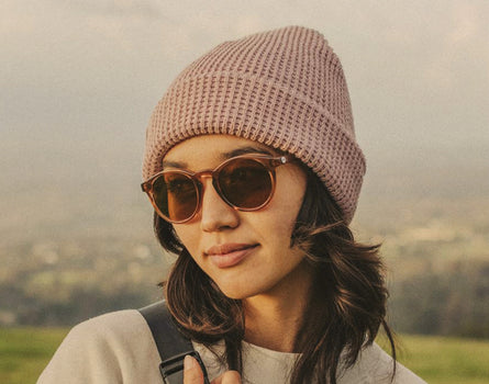 woman wearing sunski sunglasses and sunski winter sun beanie