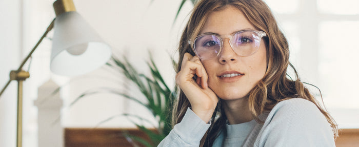 Woman wearing blue light blocking computer glasses at work.