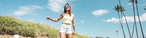 Best Beach Sunglasses and Surf Sunglasses - Woman wearing blue polarized Sunski surf sunglasses at the beach