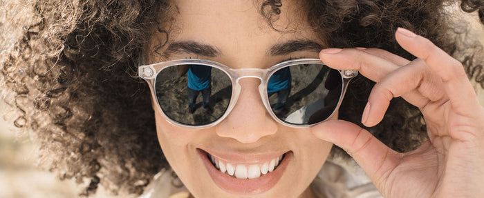 woman wearing sunski clear framed sunglasses