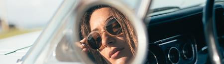 Retro Sunglasses - women wearing retro sunglasses looking in vintage car side mirror