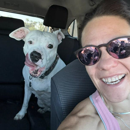 Woman and white dog in a car