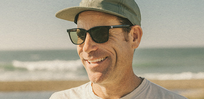 man at the beach in sunski sunglasses