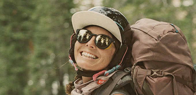 woman backpacking in tera black gold sunglasses