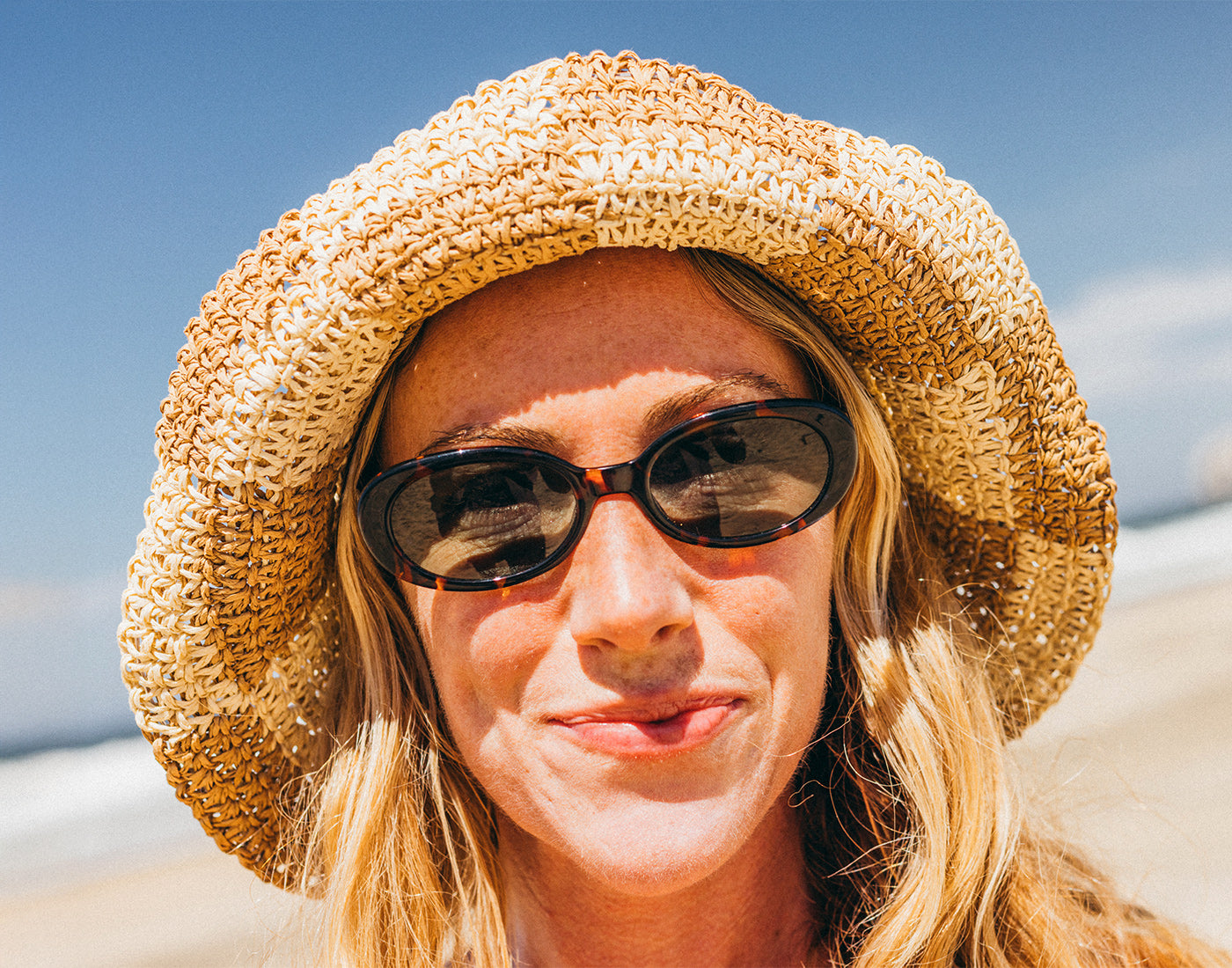 woman wearing sunski bianca tortoise forest at the beach