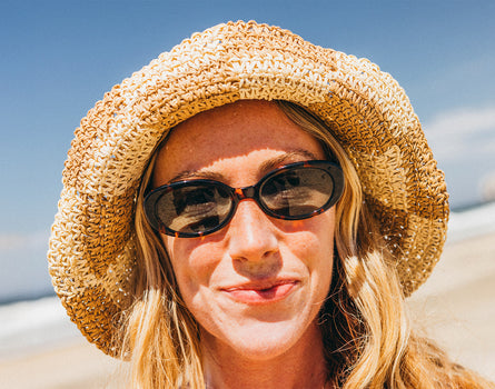 woman wearing sunski bianca tortoise forest at the beach