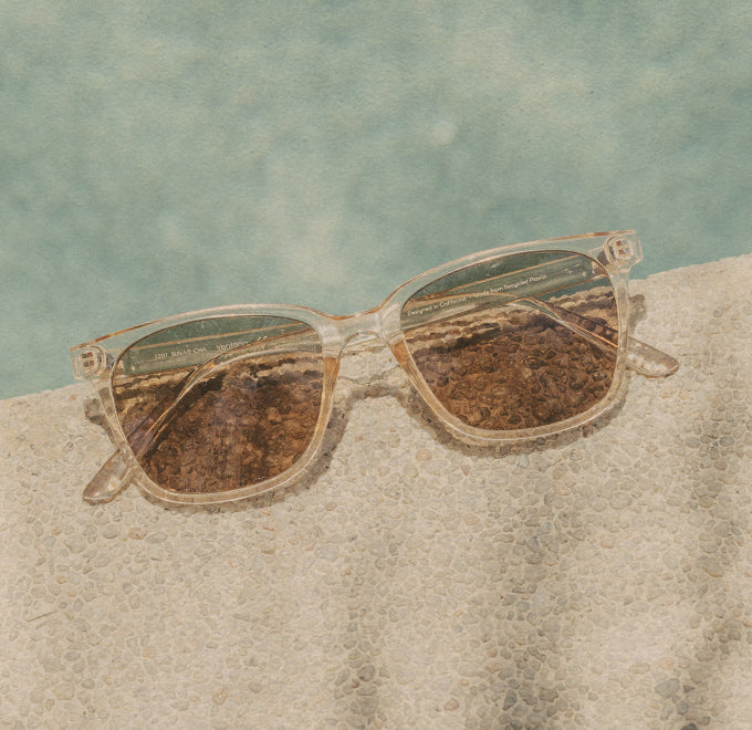 sunski clear sunglasses by a pool 