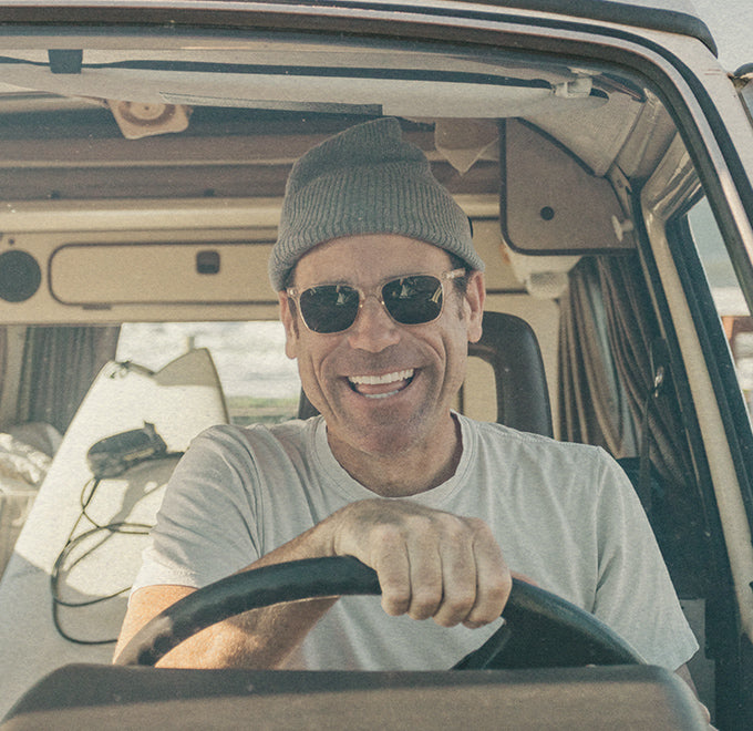 man driving a car wearing sunski clear sunglasses