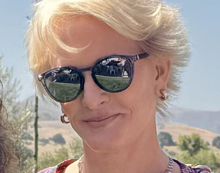 Woman wearing sunglasses with a scenic background