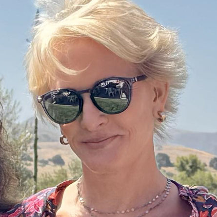 Woman wearing sunglasses with a scenic background