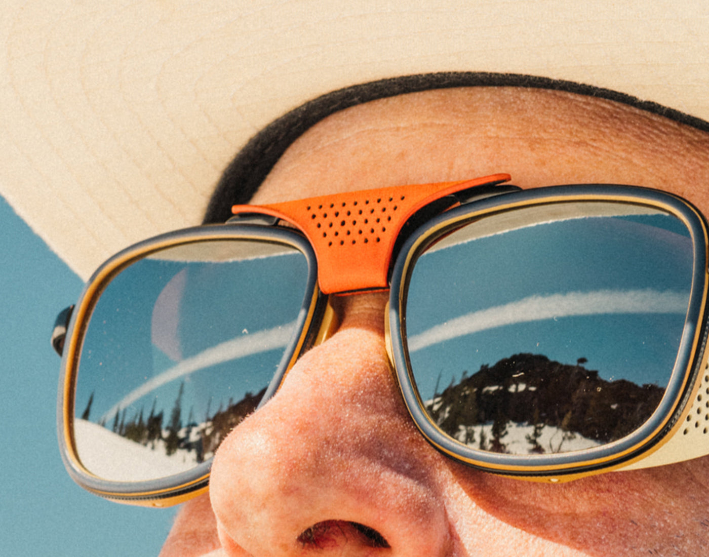 close up of sunski ferrata orange centerpiece on sunglasses