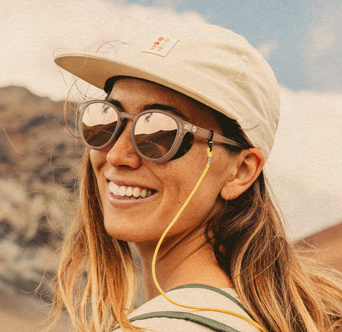 girl smiling wearing sunski tera sunglasses