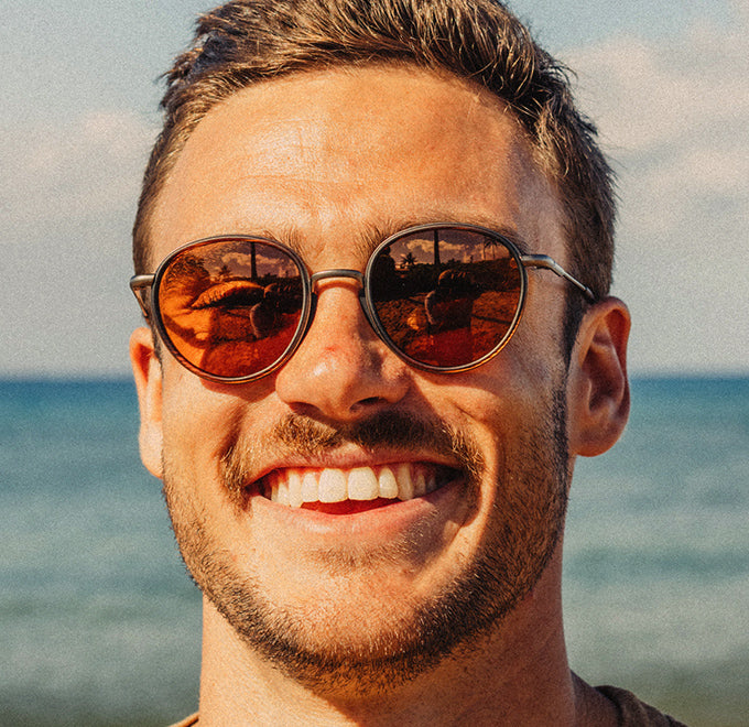 guy smiling wearing sunski baia sunglasses