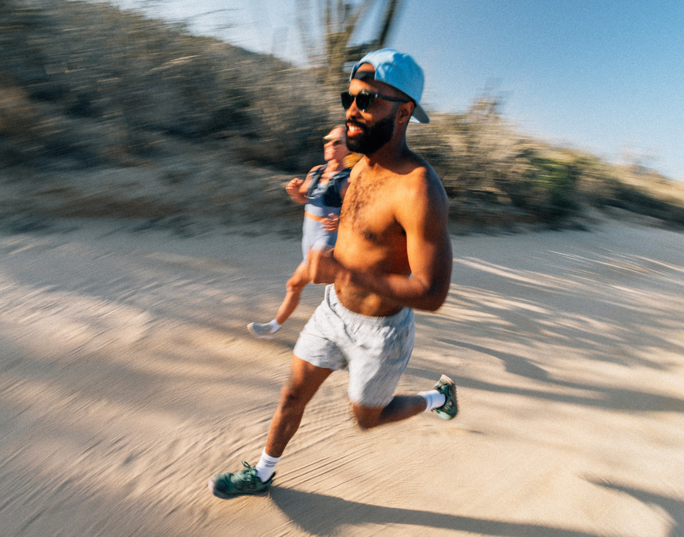 guy running in chase the sun hat