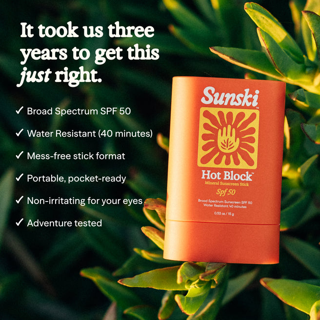 Sunski Hot Block sunscreen stick with green leaves in the background