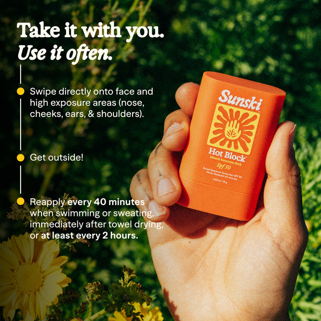 Hand holding a Sunski sunscreen stick with application instructions on a natural background