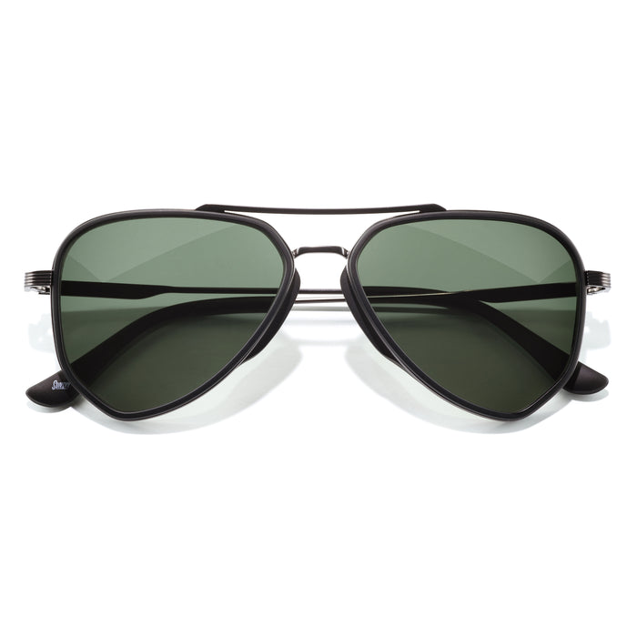 Aviator sunglasses with black frame and green lenses on a white background