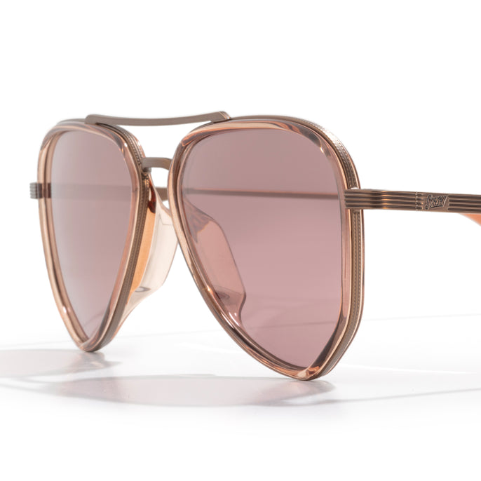 Rose gold sunglasses with pink lenses on a white background