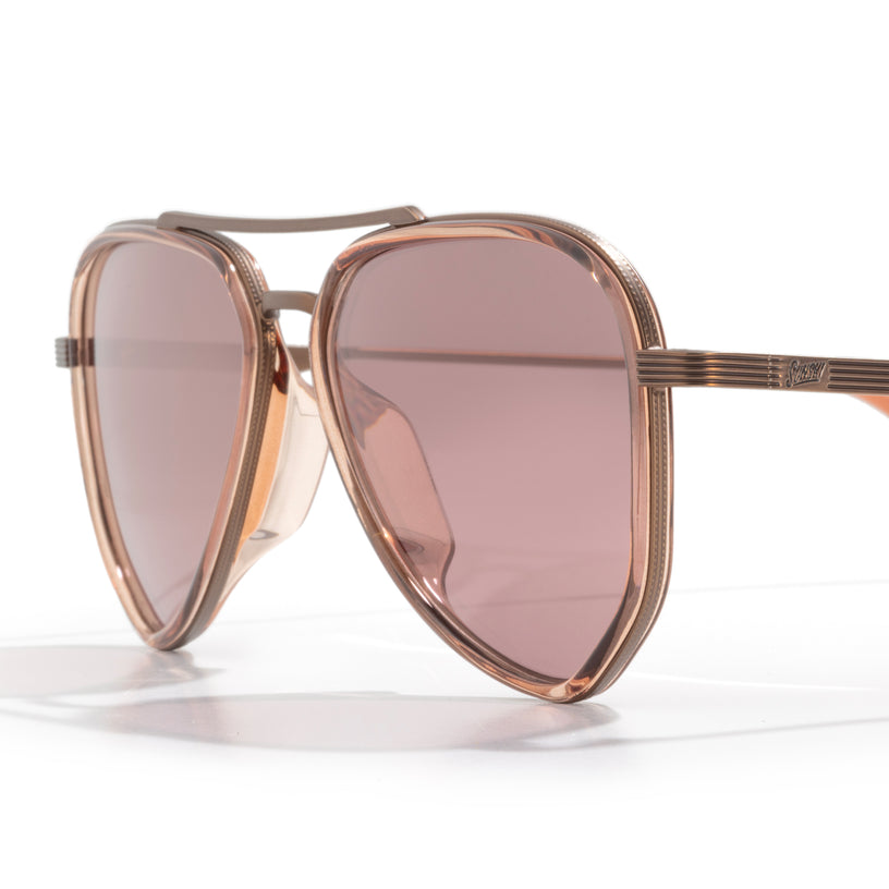 Rose gold sunglasses with pink lenses on a white background
