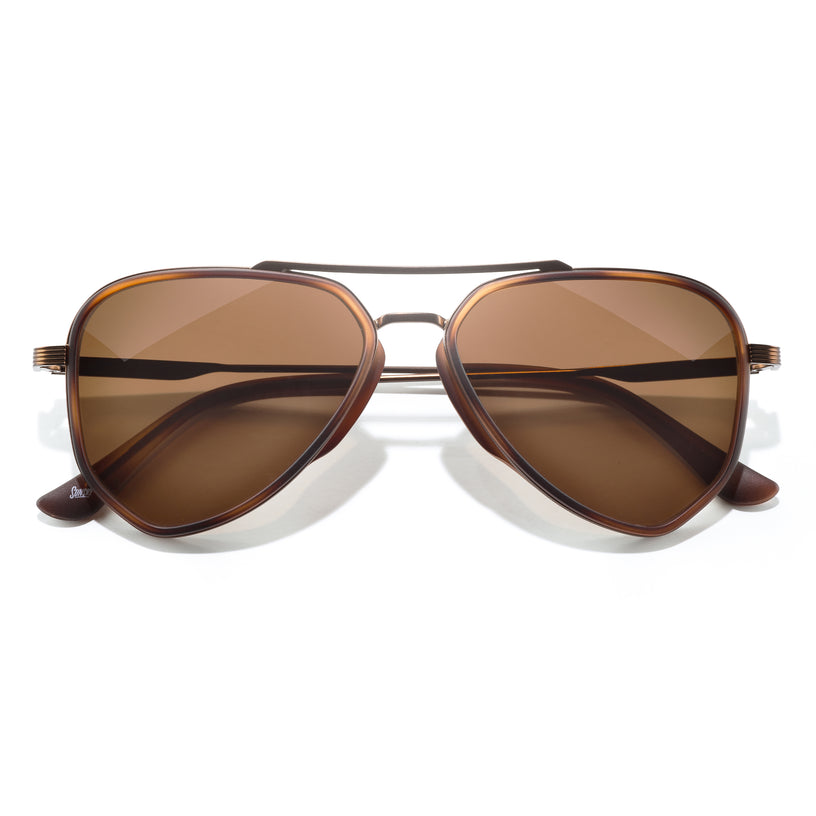 Brown sunglasses with a gold frame on a white background